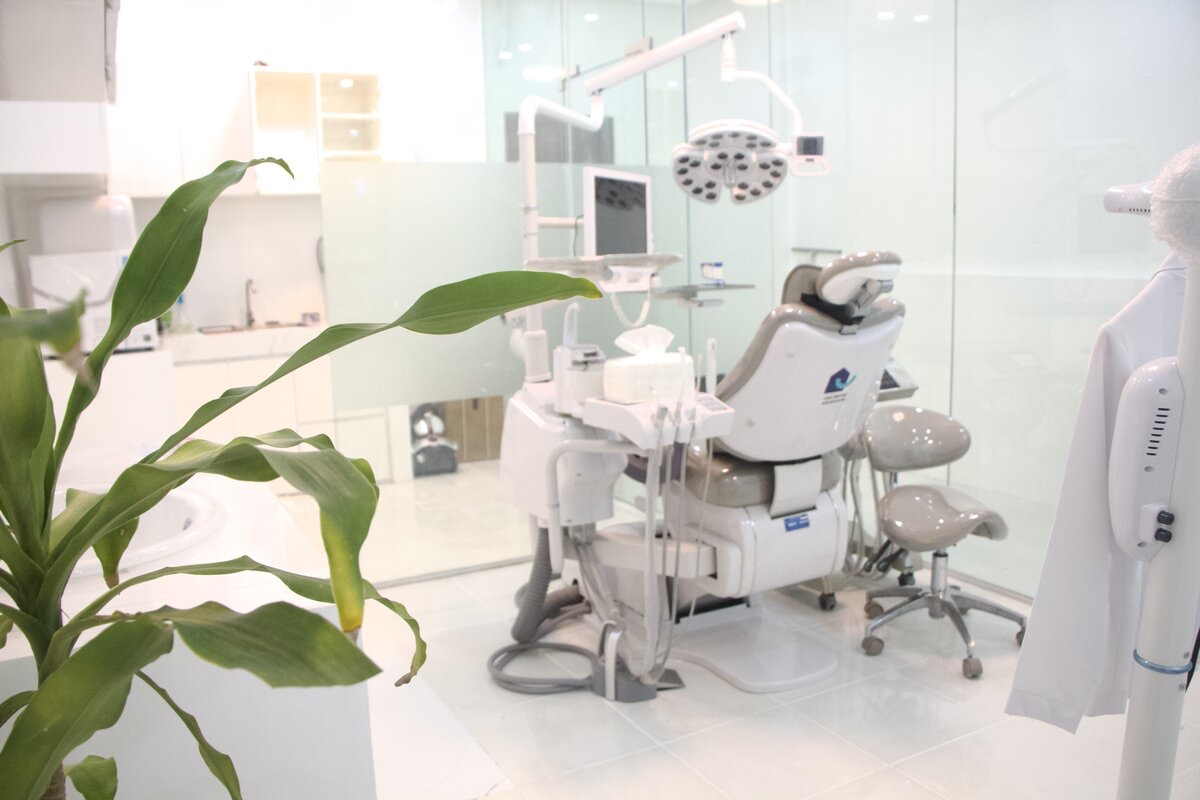 Modern dental chair in a glass-walled treatment area
